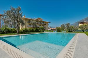 a swimming pool in front of a villa at Hotel Astoria - 3stelle S in Malcesine