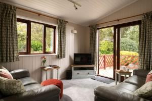 a living room with a couch and a television at L23 Cormorant in Truro