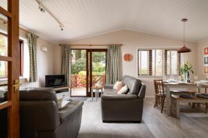 a living room with two couches and a table at L23 Cormorant in Truro