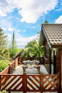 a wooden deck with tables and chairs on a house at L23 Cormorant in Truro