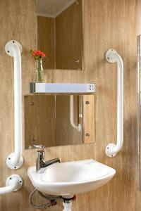 a bathroom with a sink and a mirror at L23 Cormorant in Truro +10 photos