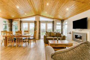 a living room with a television and a dining room at Field View 2 bed 'S'- Sycamore in Eye