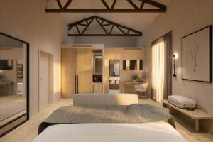 a bedroom with a large white bed and a room with at Castilla Termal Palacio de Avellaneda in Peñaranda de Duero