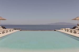 a swimming pool with a view of the ocean at Filomare Oia Suites in Oia