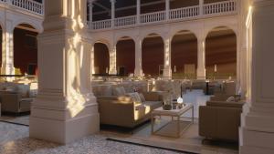 a lobby with couches and tables in a building at Castilla Termal Palacio de Avellaneda in Peñaranda de Duero