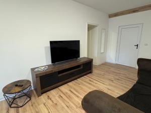 a living room with a flat screen tv and a couch at Ferienwohnung Mimi in Wernigerode