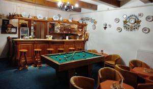 a room with a pool table and a bar at Penzión ERIKA in Vysoké Tatry