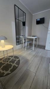 a living room with two tables and a rug at Via VOLTA 2025 Refresh 2 Bedroom Apartment in Płock