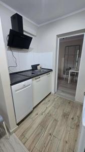 a kitchen with a counter and a table in a room at Via VOLTA 2025 Refresh 2 Bedroom Apartment in Płock +9 photos