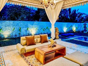 a living room with a couch and a table at Hafrana Villa by AGATA - 700sqm 2BR Villa with Private Pool & Jacuzzi in Sidemen