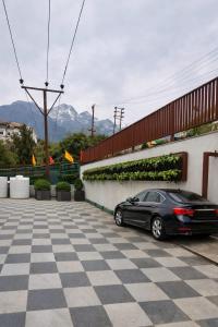 a black car parked in a parking lot at Maa Trinayani Palace in Katra