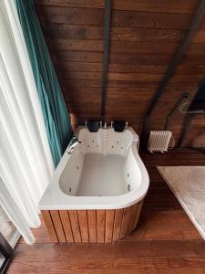 a bath tub in a room with a wooden ceiling at Bona Dea in Cayeli