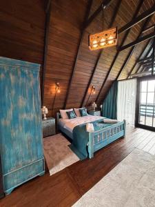 a bedroom with a bed in a wooden room at Bona Dea in Cayeli