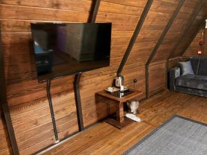 a living room with a flat screen tv on a wall at Bona Dea in Cayeli