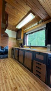 a kitchen with a sink and a window in a room at Chata pod Černou horou in Rudník