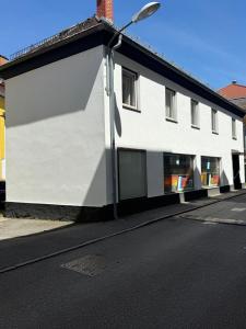 a white building with a street light on the side of it at Ferienwohnung Max in Mürzzuschlag