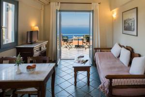 a living room with a couch and a table at MIRA Resort Maizonettes in Lefkada