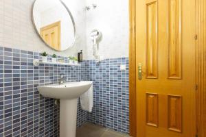 a blue tiled bathroom with a sink and a mirror at Precioso Apartamento a estrenar. La Placeta in Riópar +31 photos