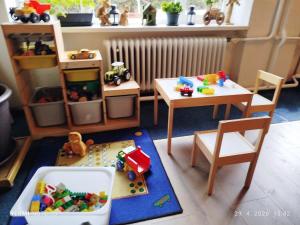 a toy room with a table and chairs and toys at Penzión ERIKA in Vysoké Tatry