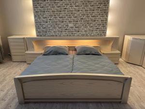 a bed in a bedroom with a brick wall at Ferienwohnung Mimi in Wernigerode