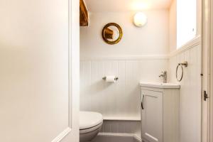 a white bathroom with a toilet and a sink at 2 Bed in Embleton oc-nb1960 in Embleton +14 photos