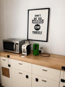 a microwave and a toaster on a kitchen counter at StaySpace in Graz