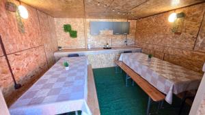 a room with two tables and a sink in it at Apartman DIVAN in Ladimirevci +26 photos
