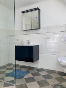 a bathroom with a sink and a toilet at Haus Ambiente in Reil +22 photos