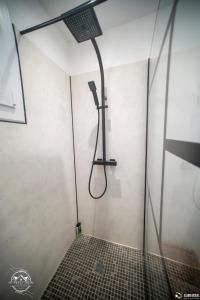 a shower in a bathroom with a glass door at Les Embruns - Mer - Terrasse in Le Grau-du-Roi +14 photos