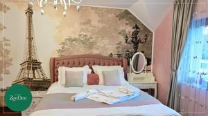 a bedroom with a bed with the eiffel tower at Sinaia ZenDen - Private Villa & SPA in Sinaia