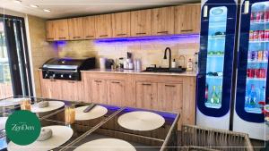 a kitchen with wooden cabinets and tables and a counter at Sinaia ZenDen - Private Villa & SPA in Sinaia +45 photos