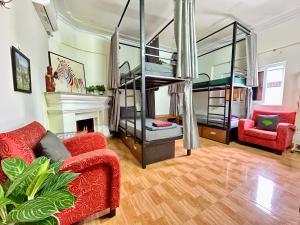 a living room with a red couch and a bunk bed at Hava Hostel Lang Son in Lạng Sơn +24 photos