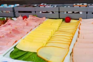 a cake with cheese and meats on a table at Hotel Fellini a Fontana di Trevi in Rome
