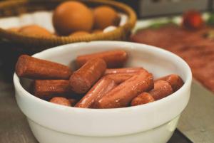a white bowl filled with hot dogs on a table at Hotel Fellini a Fontana di Trevi in Rome