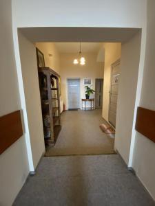 an empty hallway of a home with a door and a table at Hotel Koruna penzion in Teplice nad Metují