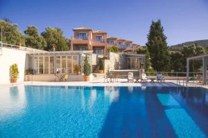 a large swimming pool in front of a house at MIRA Resort Maizonettes in Lefkada