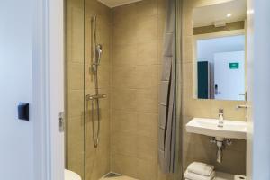 a bathroom with a shower and a sink at Easy Stay Næstved in Næstved +16 photos