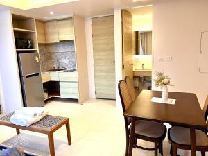 a kitchen and dining room with a table and a dining room at Coconut Condo Aonang in Ao Nang Beach