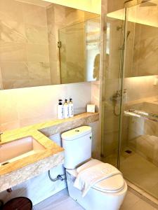 a bathroom with a toilet and a sink and a shower at Coconut Condo Aonang in Ao Nang Beach +9 photos