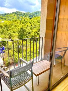 a bench sitting on a balcony with a view at Coconut Condo Aonang in Ao Nang Beach