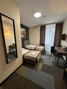 a hotel room with a bed and a mirror at Centrum Konferencyjno-Apartamentowe Mrówka in Warsaw +29 photos