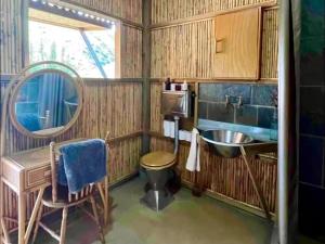 a small bathroom with a sink and a mirror at Tula Retreat - Secluded Karoo Escape - Hot Tub - Private Boat Arrival in Calitzdorp +23 photos