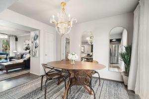 a dining room with a table and chairs at Spacious Loft Condo w Pool & Fireplace in Dallas