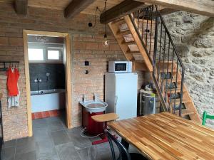 a small kitchen with a refrigerator and a staircase at Studio 611 in Třebíč +14 photos