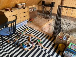 a room with a chair and toys on the floor at Studio 611 in Třebíč