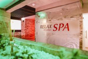 a sign on the wall of a restaurant at Hotel Relax & Resort Sovata in Sovata