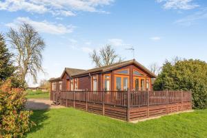 a large wooden house with a large deck at Field View 2 bed-No pets-Hornbeam in Eye