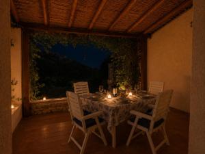 a table with candles and chairs on a patio at Alba Ruja Residence 2 with Pool Close to All Amenities in Porto Cervo