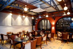 a restaurant with tables and chairs in a room at Comfort Hotel Kishore Azamgarh in Āzamgarh