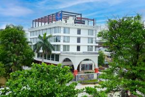 a white building with a sign on top of it at Comfort Hotel Kishore Azamgarh in Āzamgarh